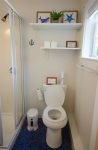 Lower level bathroom with new paint, lights, toilet, tile